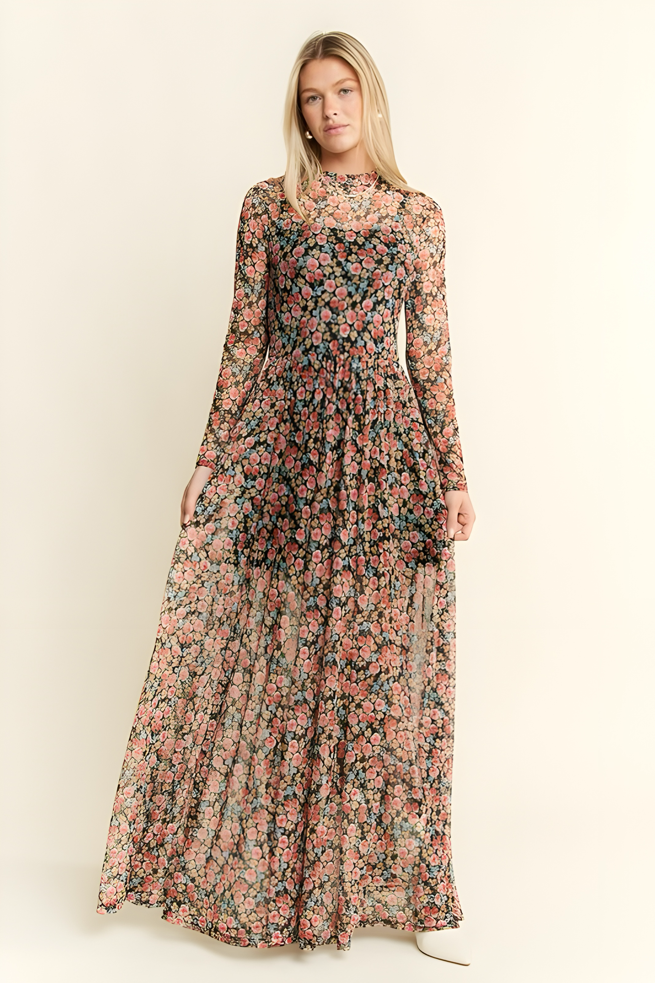 Blonde woman wearing long sleeve floral mesh maxi dress featuring pink and peach flowers on black sheer fabric background