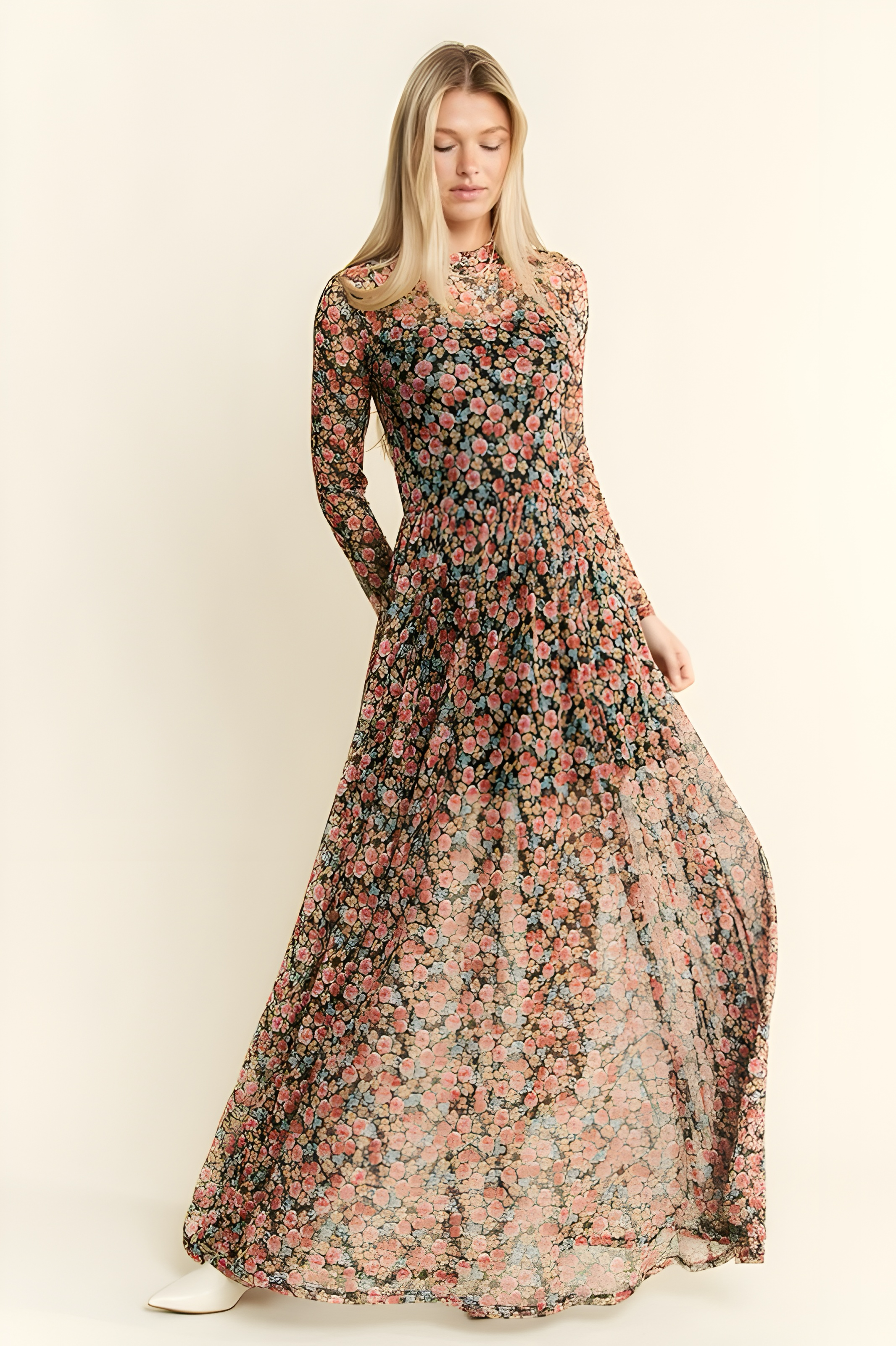 Blonde woman wearing fitted long sleeve floral mesh maxi dress with pink and peach flowers on dark fabric background