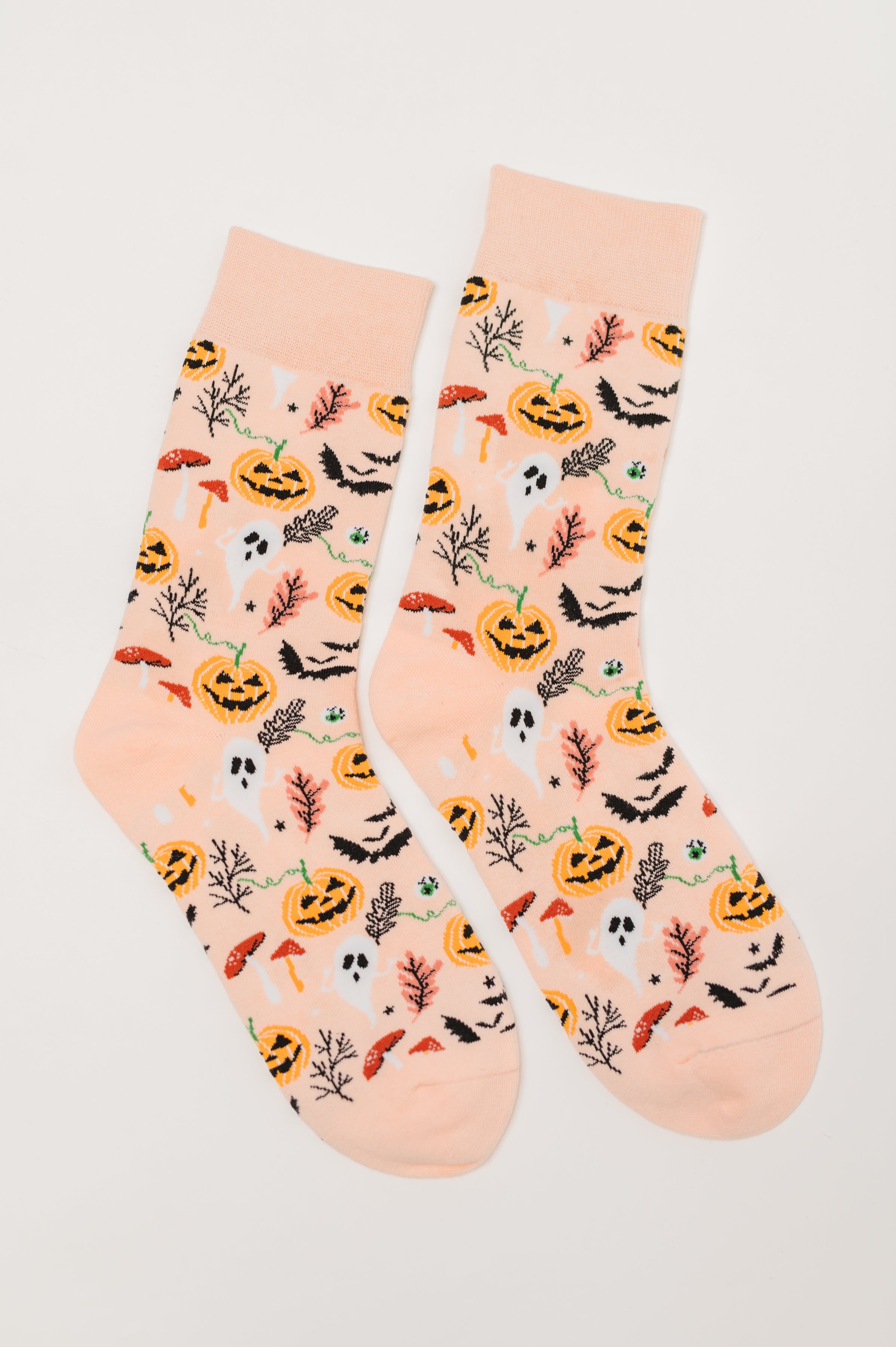 Orange quarter socks featuring Halloween-themed pumpkins, ghosts, bats, mushrooms, and spooky branches on a light background
