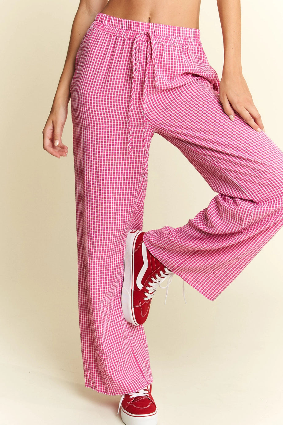 Pink In The Groove Checkered Print Pants with elastic drawstring waist and flowing wide legs paired with red canvas sneakers