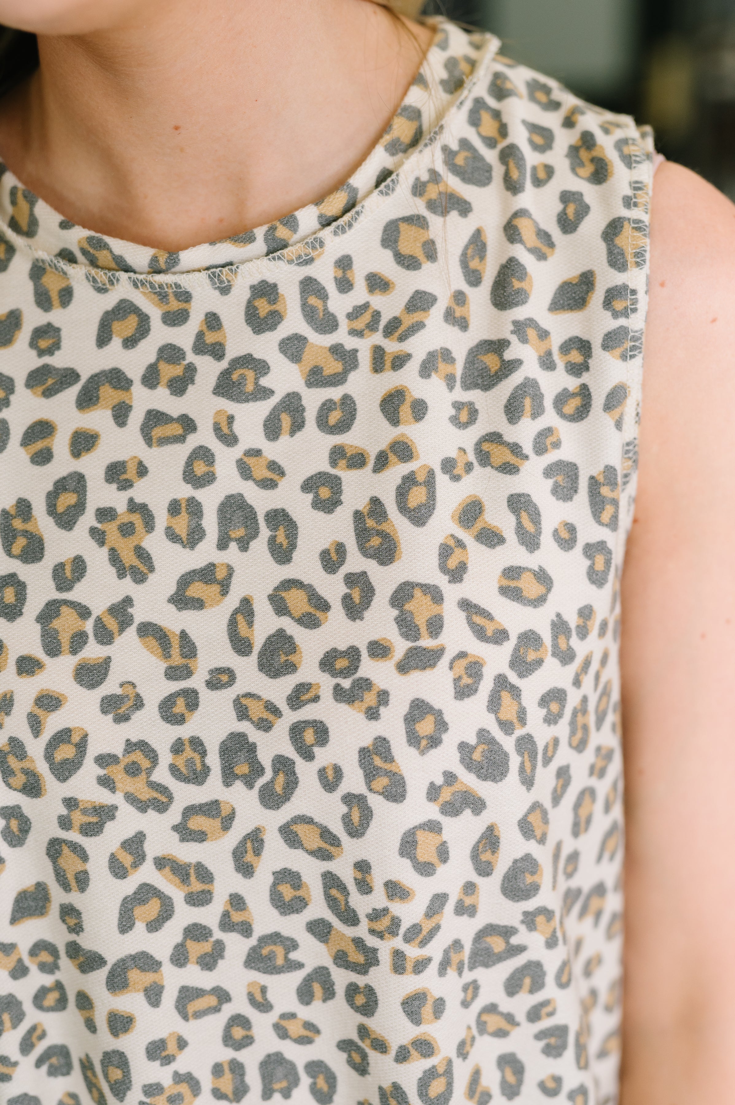 Close-up of sleeveless brown leopard print top with soft French terry fabric and a relaxed neckline
