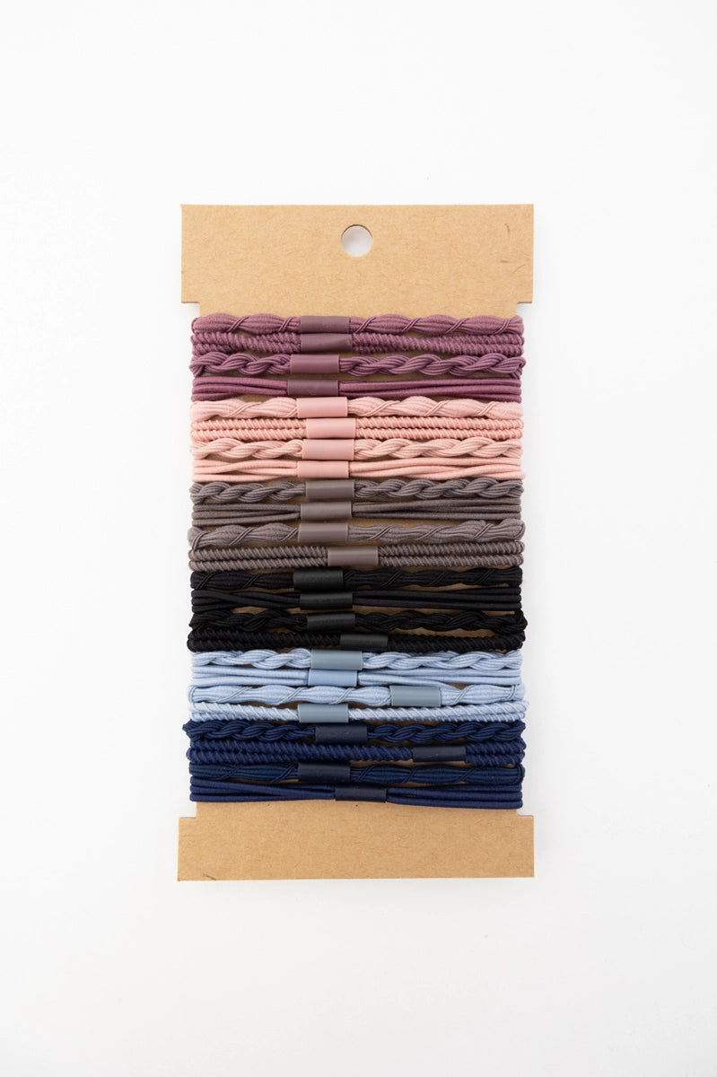 Set of stackable hair tie bracelets in night sky shades with braided and twisted textures on kraft card backing