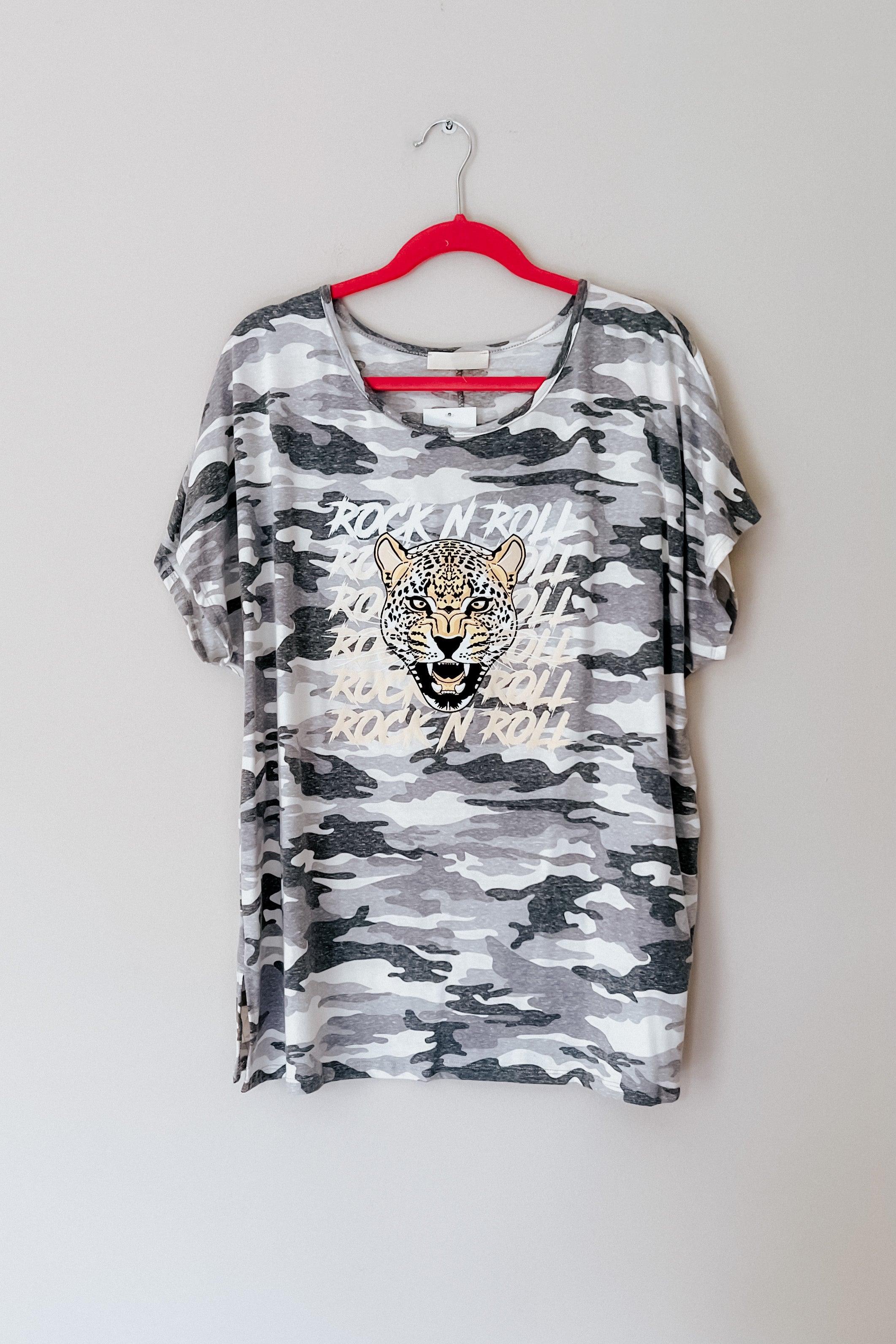 Grey camo tee with bold leopard face graphic and layered rock n roll text hanging on red hanger against plain wall
