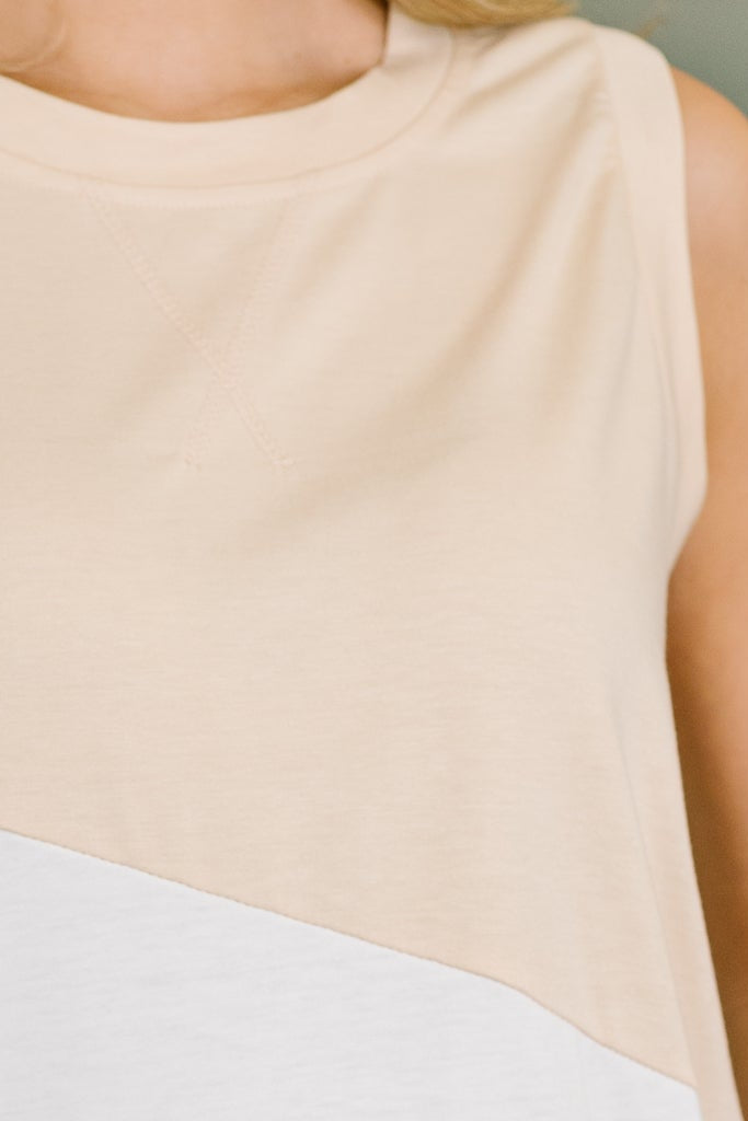 Close-up of cream sleeveless top with color block design and soft cotton fabric showing clean stitching details