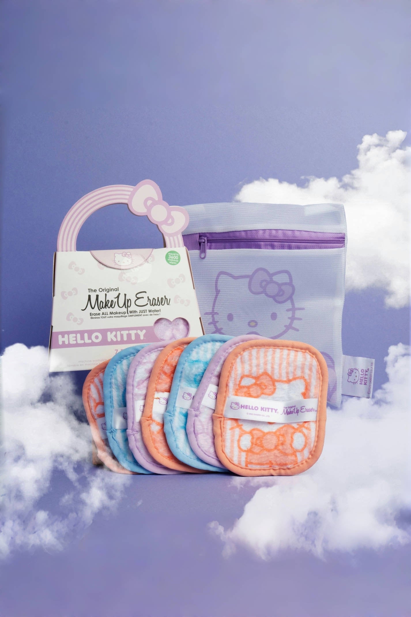 Colorful set of reusable makeup erasers with Hello Kitty designs arranged in front of a mesh bag with purple zipper and bow handle packaging