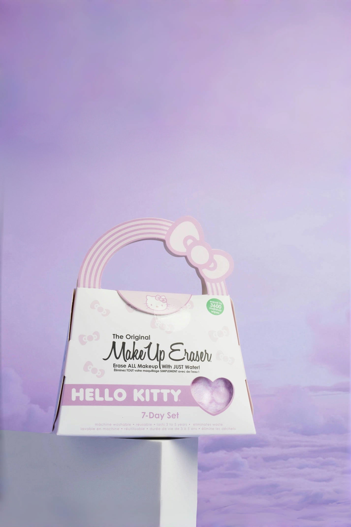 Hello Kitty themed makeup remover set with pastel pink handle against a soft purple sky background