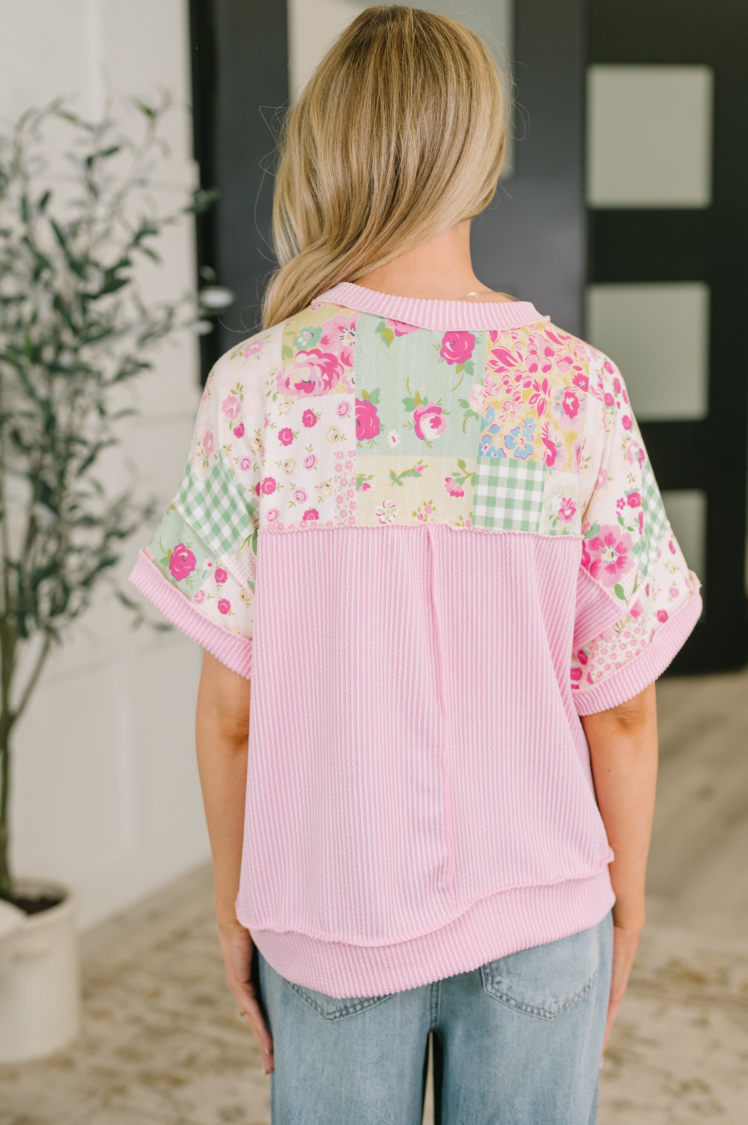 Back view of pink patchwork plush tee with floral and gingham patterns in an eclectic, size-inclusive style