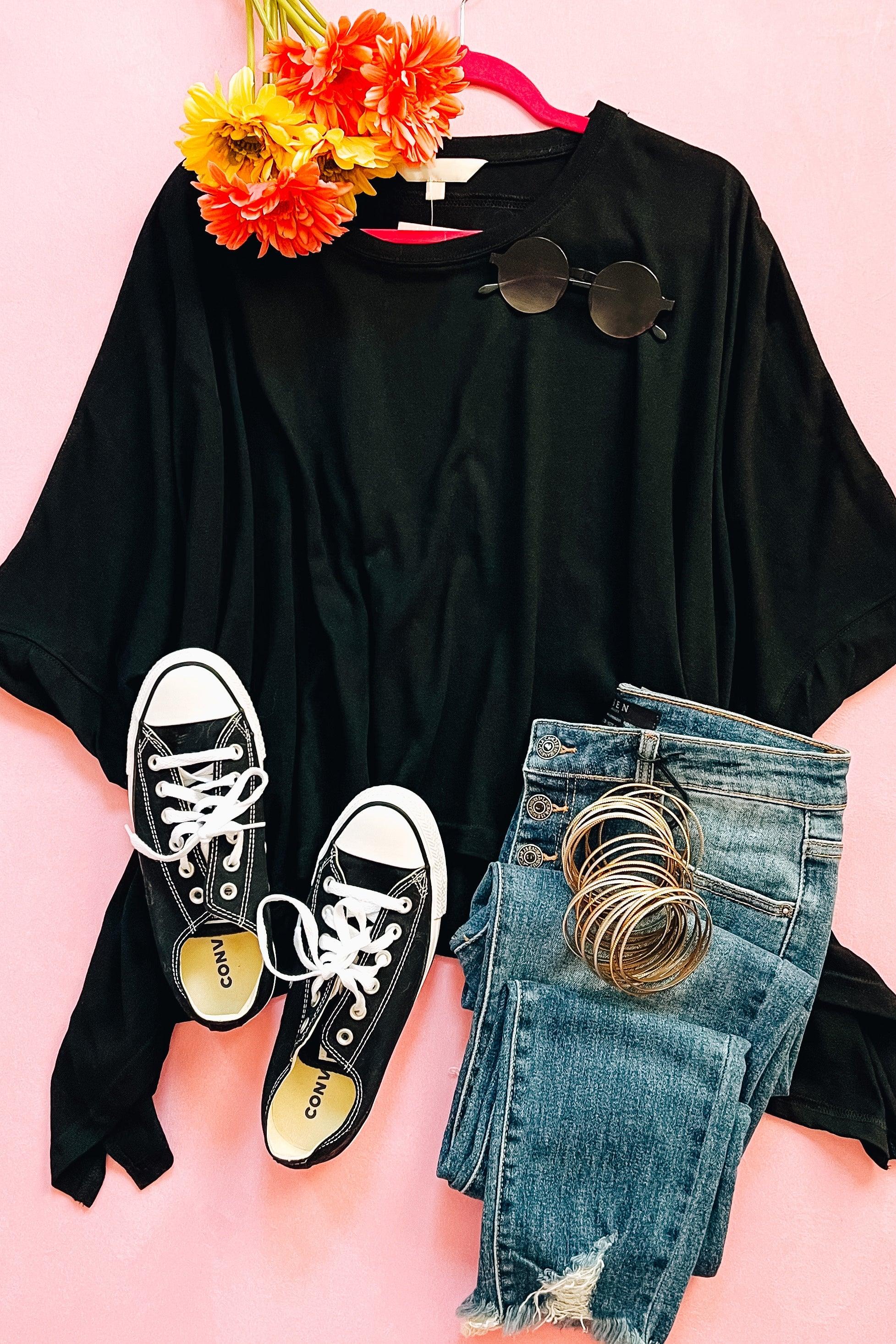 Black All My Life Boxy Top styled flat with sunglasses, black sneakers, ripped blue jeans, and orange flowers on pink background