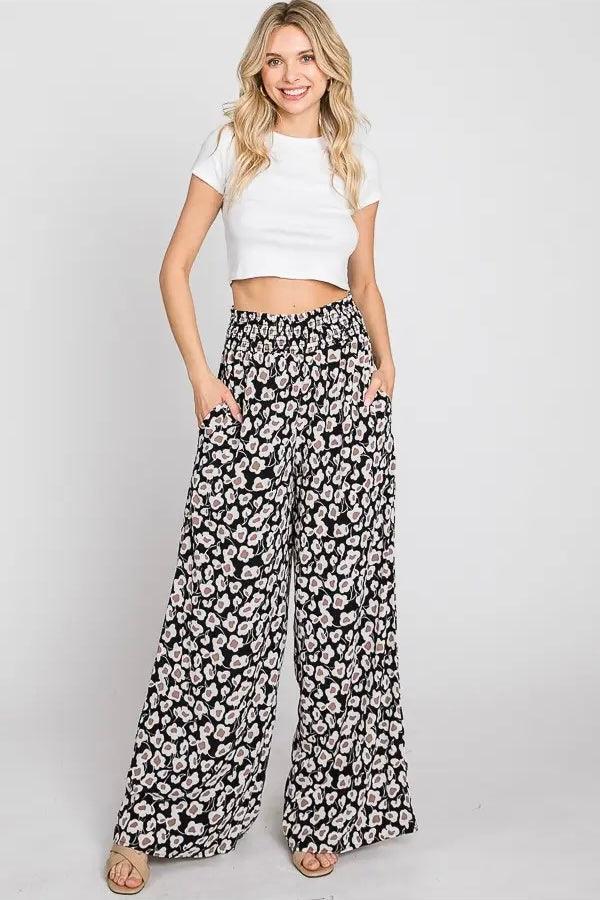 Flowers In Your Hair Retro Vintage Print Smocked Pants in black and ivory floral pattern worn with white crop top and sandals