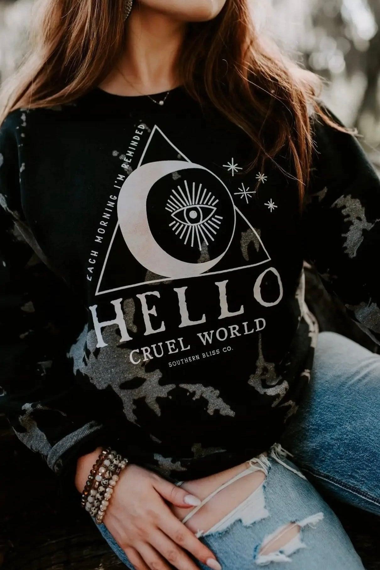 Black Hello Cruel World sweatshirt with bleached pattern and graphic design worn with distressed jeans outdoors
