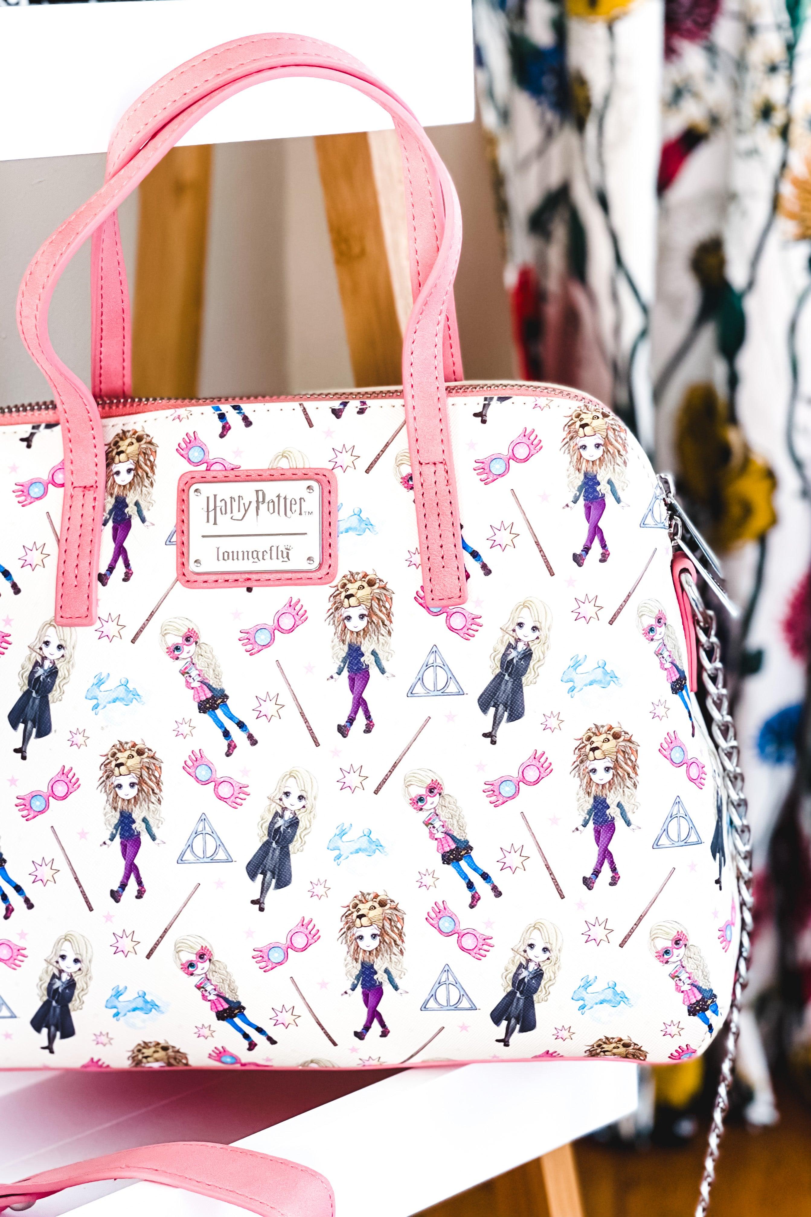 Cream loungefly handbag with pink handles featuring illustrated Harry Potter characters, magical wands, glasses, and wizard-themed symbols pattern