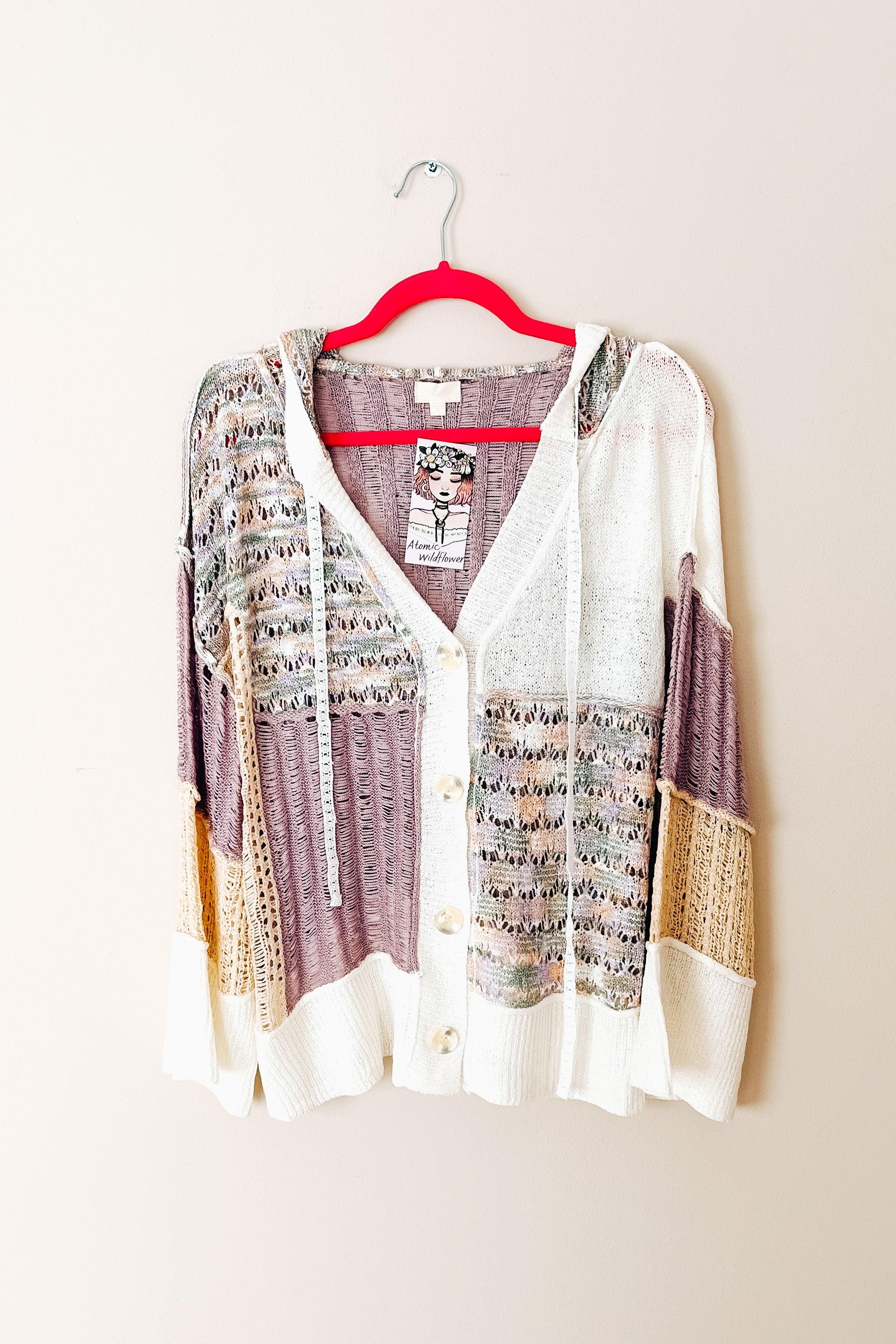 Light knit hoodie cardigan in lavender, cream, and beige with mixed textured panels and button closure