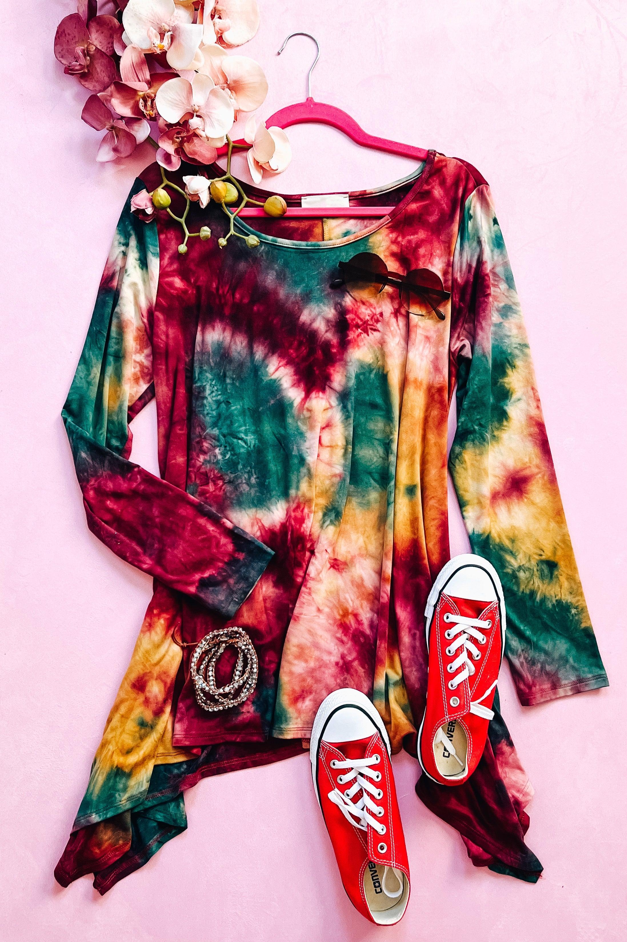 Long-sleeve ruby tie-dye top with green and yellow shades, styled with red sneakers and floral accents
