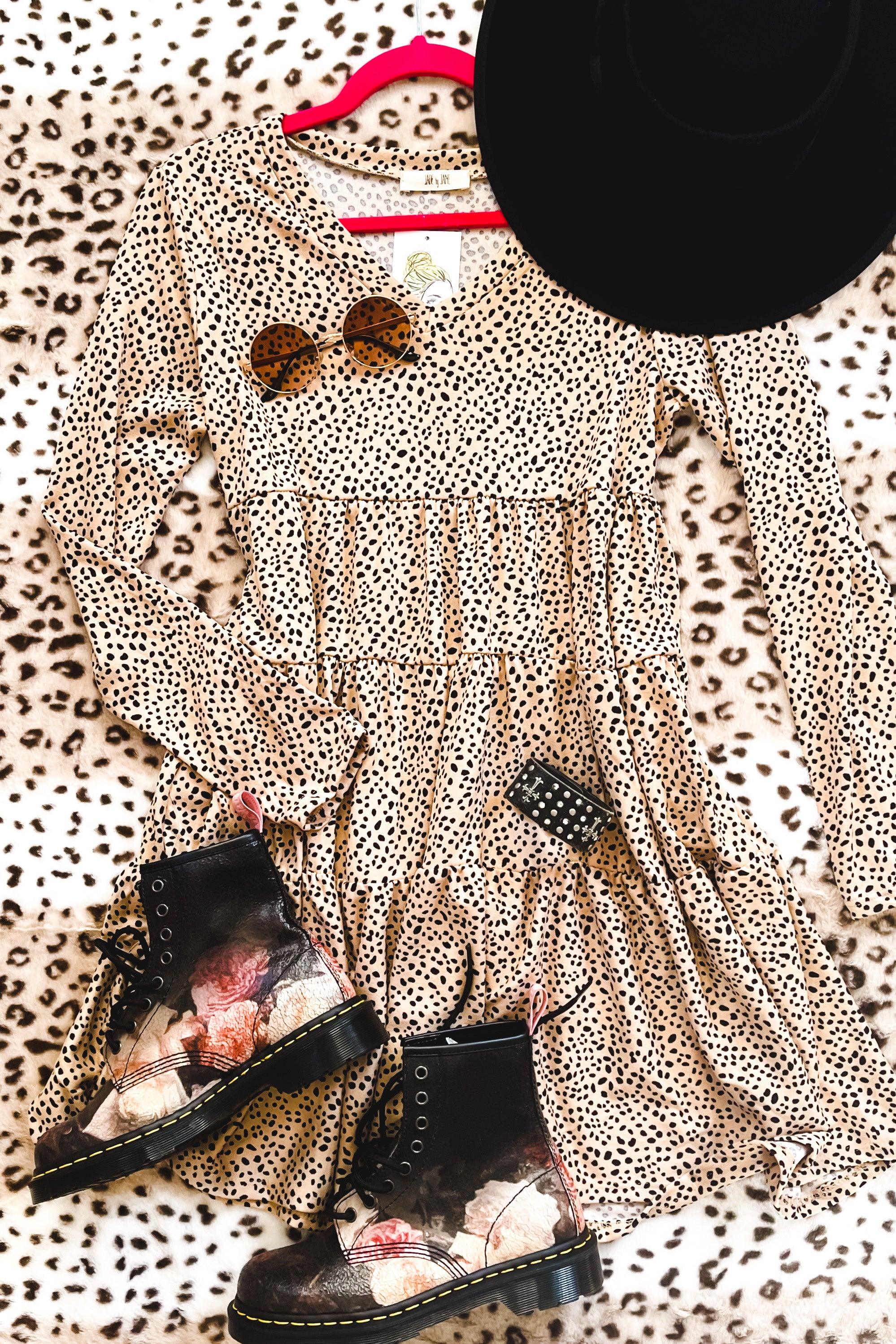 Taupe animal print dress with long sleeves paired with floral lace-up boots, round sunglasses, and black wide hat