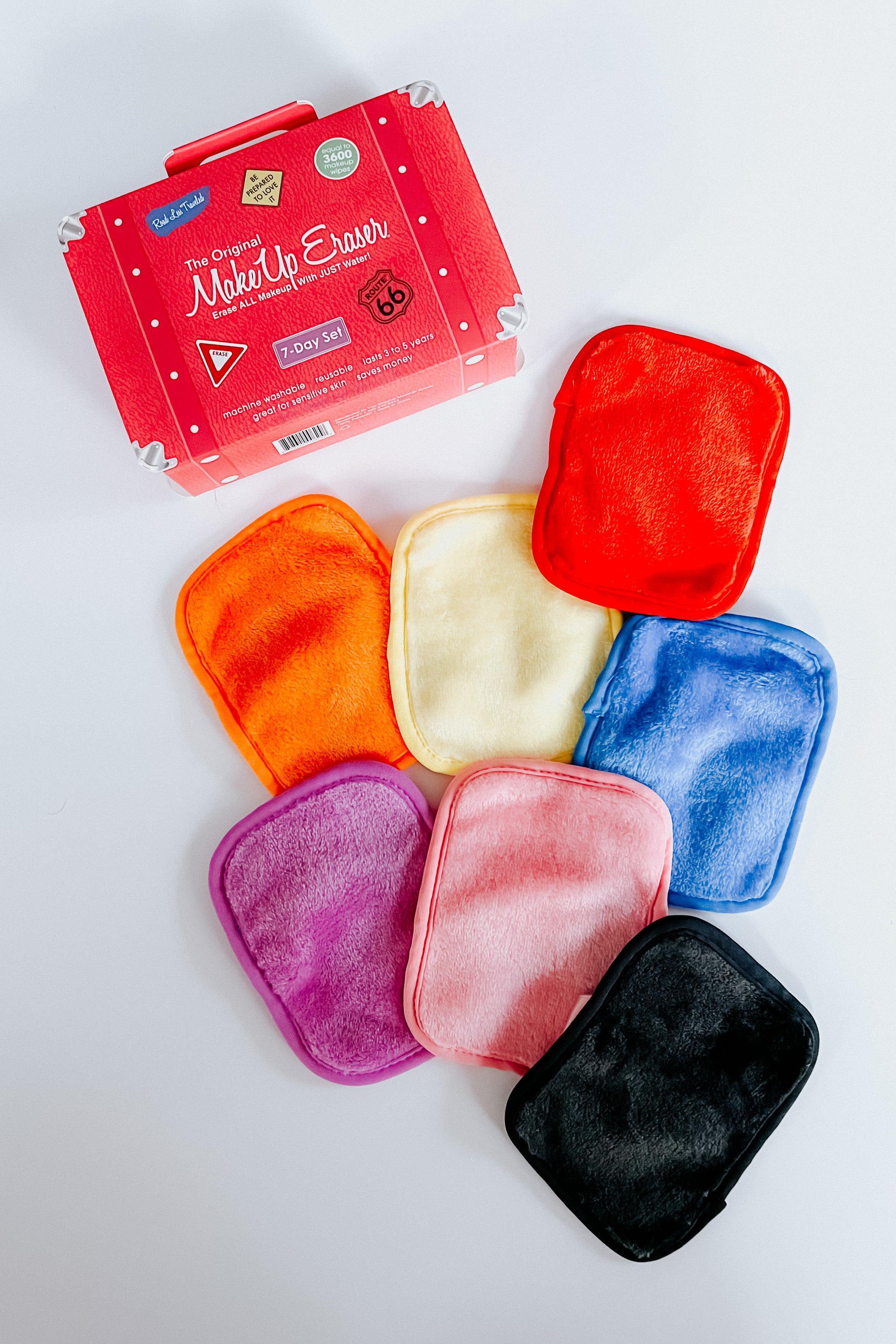 Set of seven colorful plush reusable makeup remover cloths arranged beside a vibrant red branded travel case